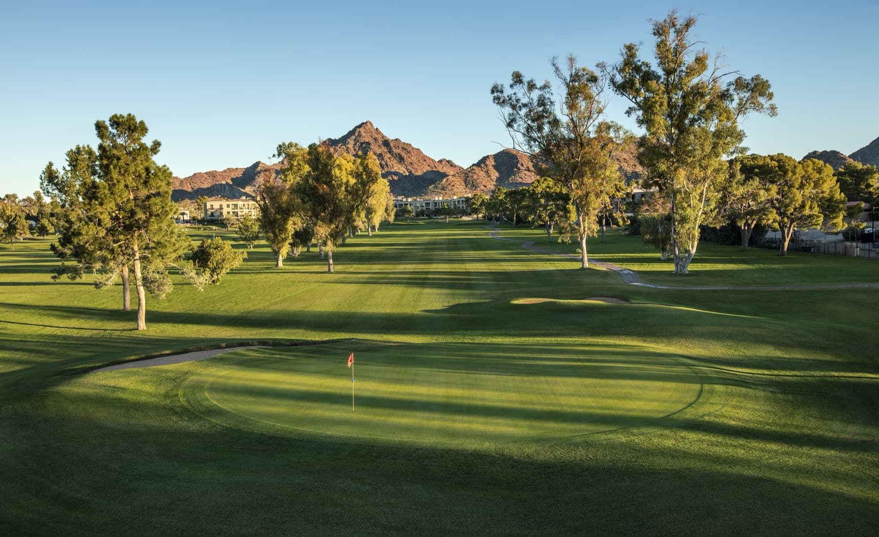 a bunkered green with the Phoenix Mountains behind