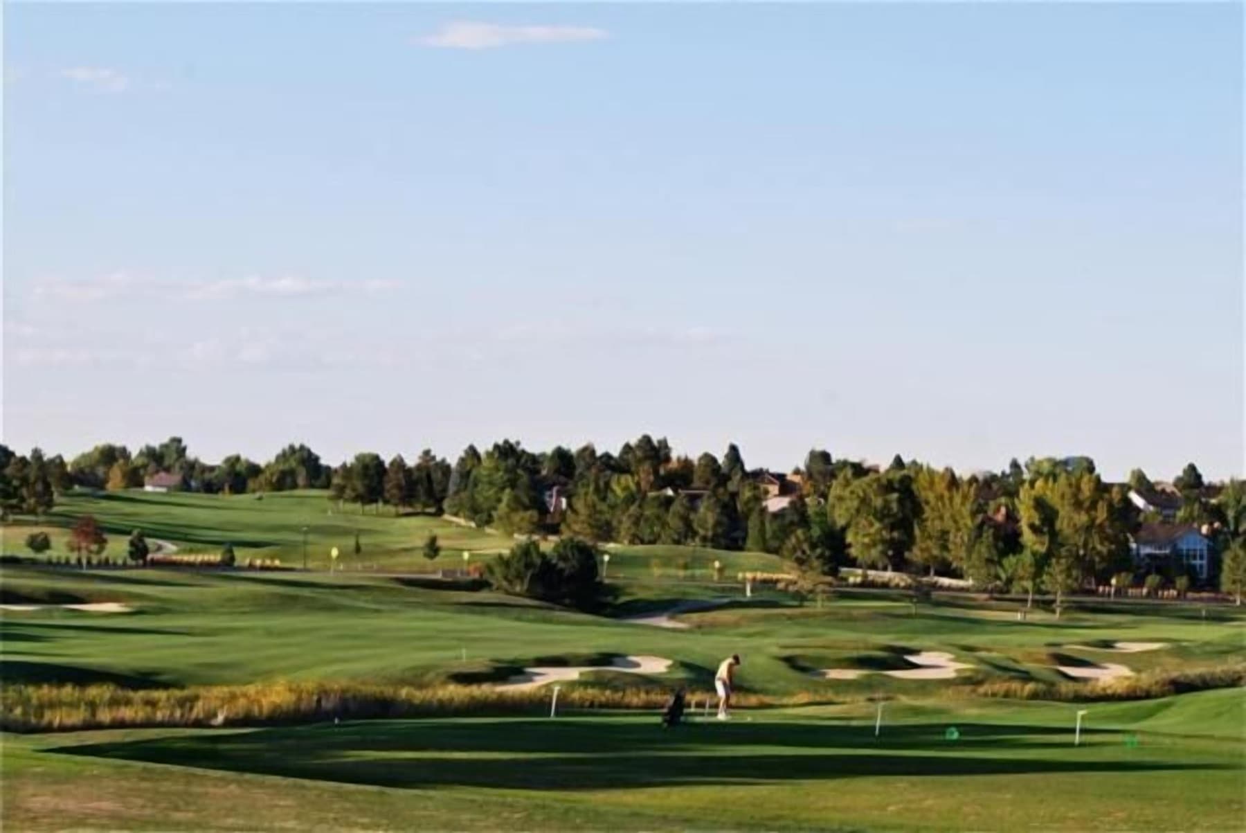 a rolling fairway toward the Denver foothills