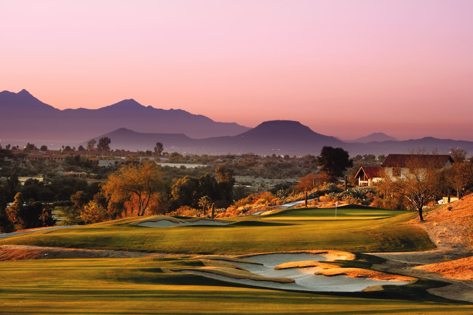 a green against the Tucson mountains at dusk